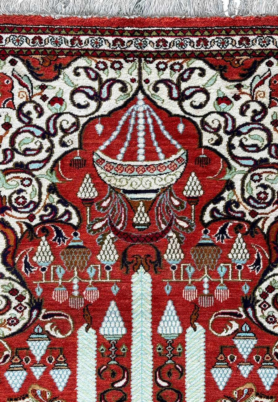 Persian Qum silk rug corner displaying the fine craftsmanship and detailed border patterns