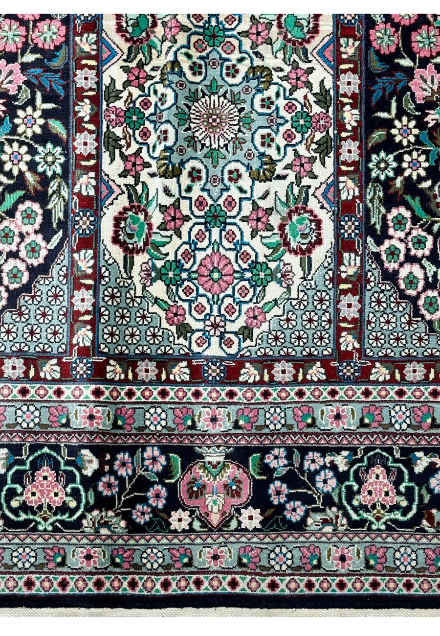 Zoomed-in view of the edge and fringe detailing of a luxurious Persian Qum silk rug