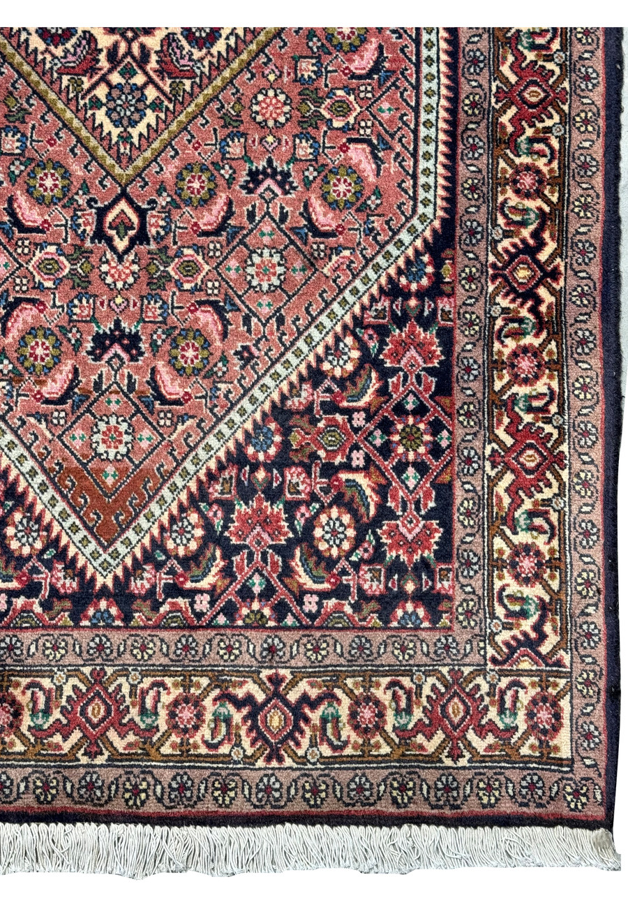Detail shot of the Persian Bijar rug's surface, highlighting the intricate weave and color depth