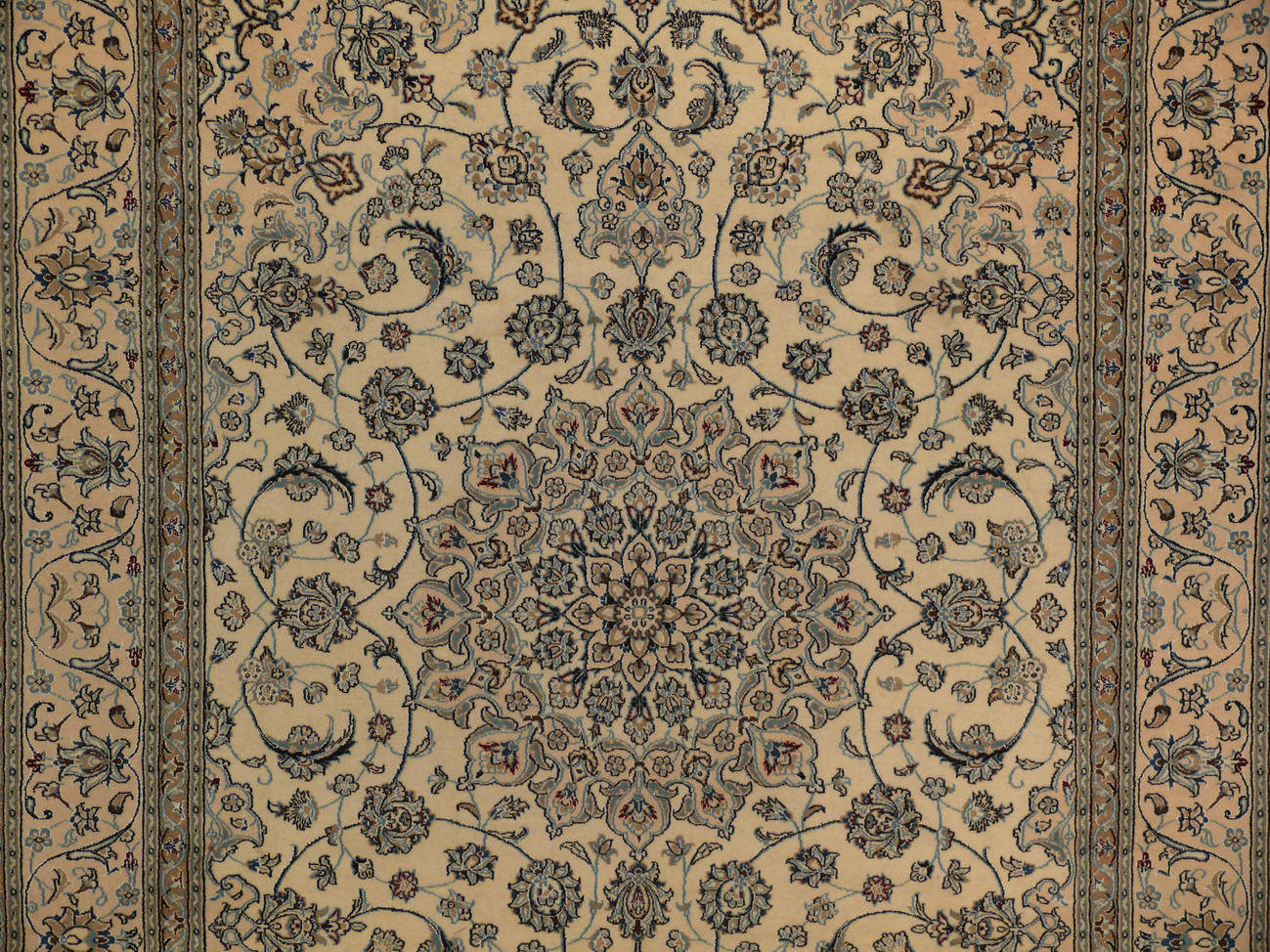 Close-up of central medallion with navy background, wine red blossoms, and ivory outlines