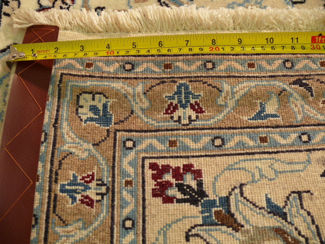 close up showing the weaving density with a ruler of a 8x11 Nain Persian Rug