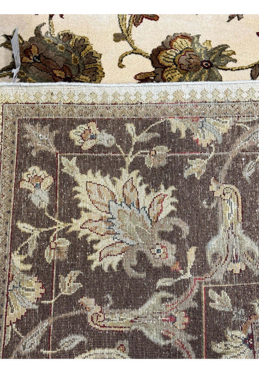 A close-up of the Chobi rug's border and fringe, showcasing the detailed patterns and texture of the rug's edge.