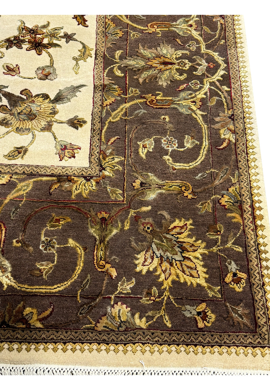 An angled close-up of the Indian Chobi rug's central design, emphasizing the intricate floral motifs and the rug's plush pile.