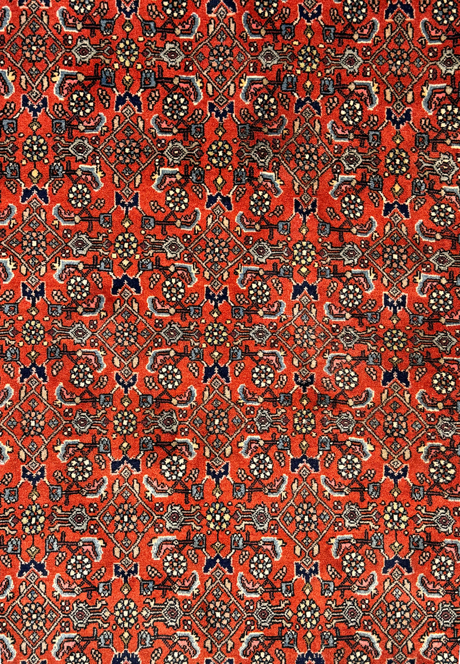 A close-up of the vintage Bijar rug's pattern, highlighting the detailed motifs and rich color palette.