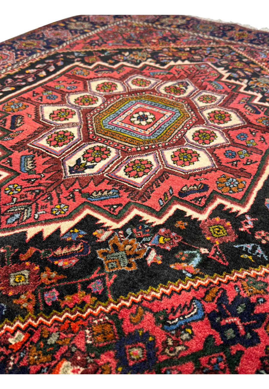 Corner detail of the Persian Gholtogh rug, highlighting the transition from the central field to the elaborate border