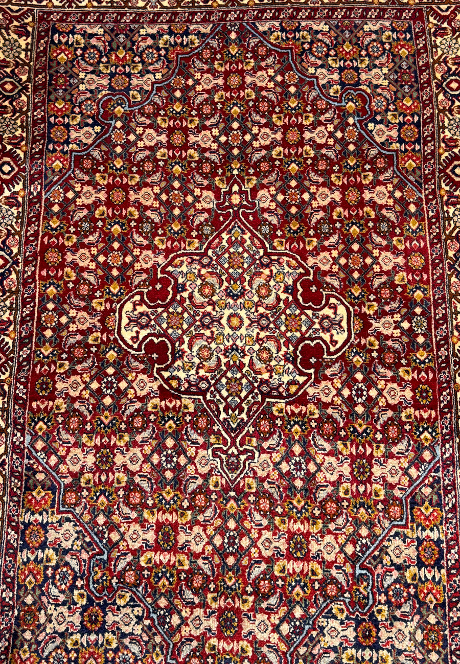 Midfield close-up of a 3 x 4'7" Persian Bidjar rug, displaying the intricacy of the weave and richness of the traditional motifs