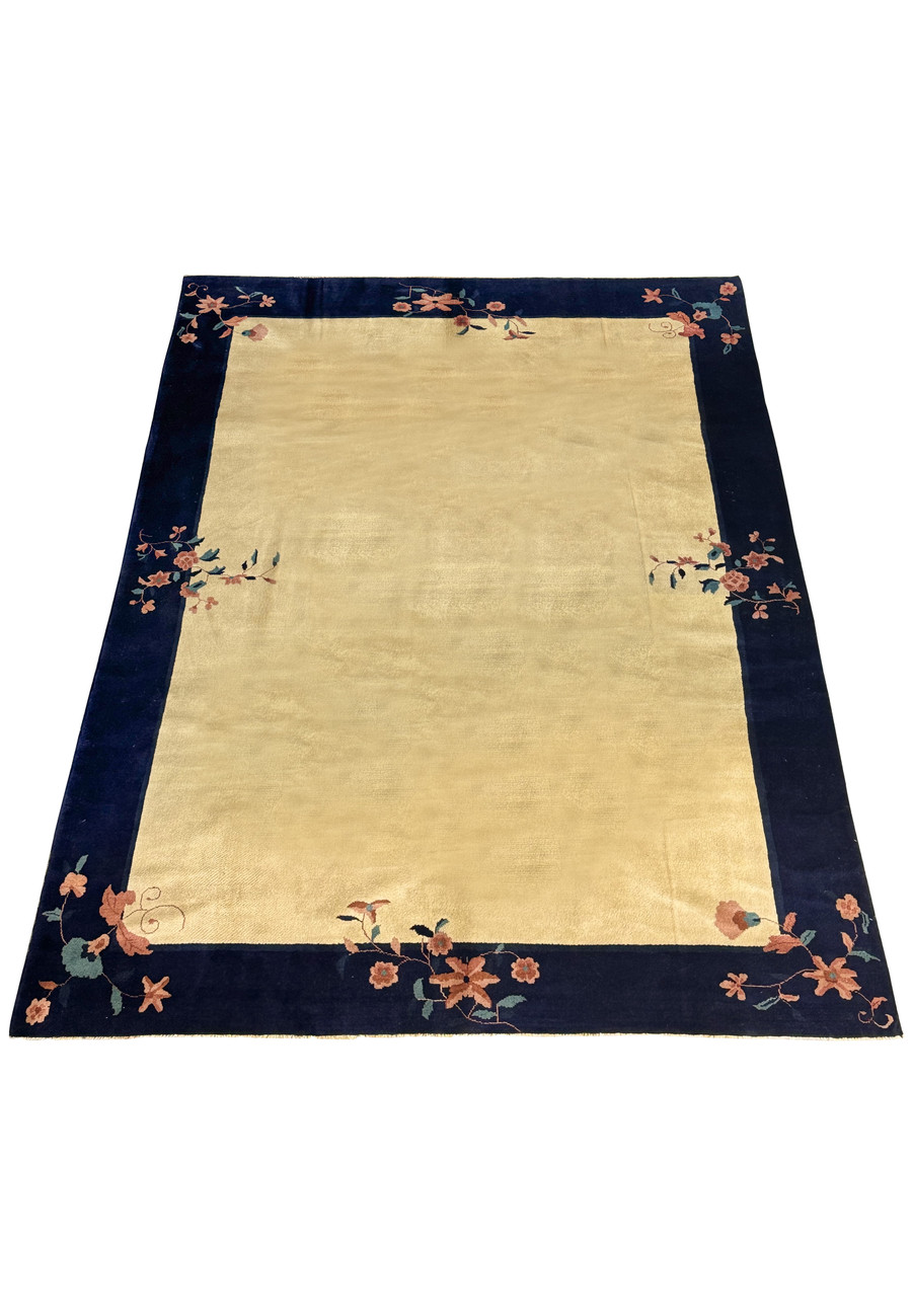 Full view of a large 8'2" x 11'2" Vintage Art Deco Rug laid out, with a detailed navy border and a beige field adorned with floral patterns