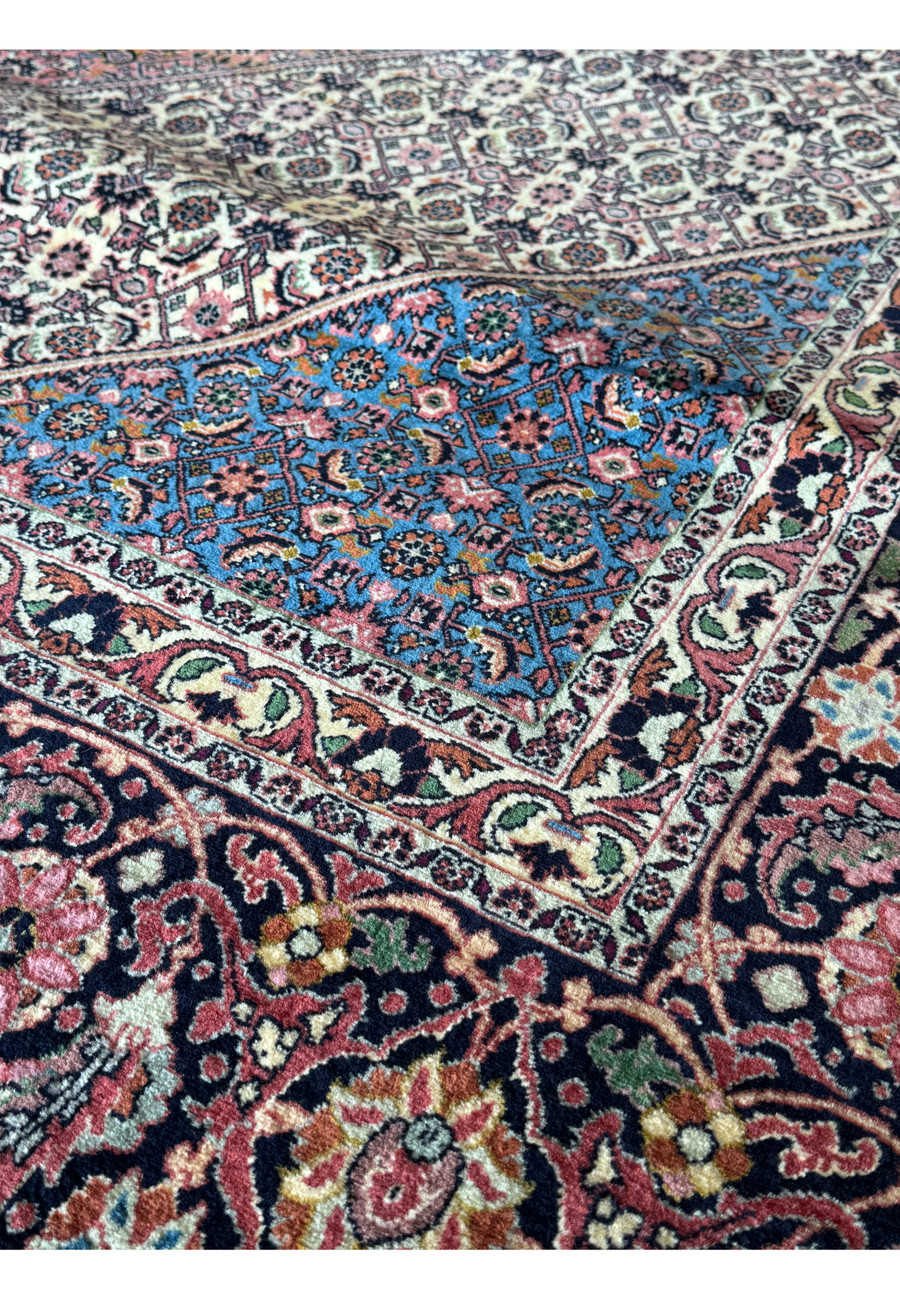 A 12x17 Bijar Persian rug featuring a central medallion surrounded by an elaborate pattern of intricate floral and geometric motifs, handwoven with exceptional craftsmanship