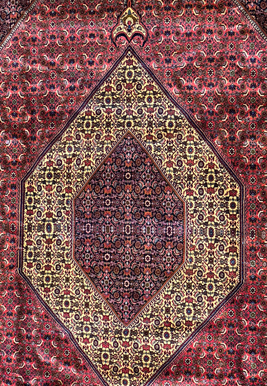 Close-up of the central medallion of the Bijar Rug, highlighting the detailed patterns and vibrant color mix of red, blue, and gold