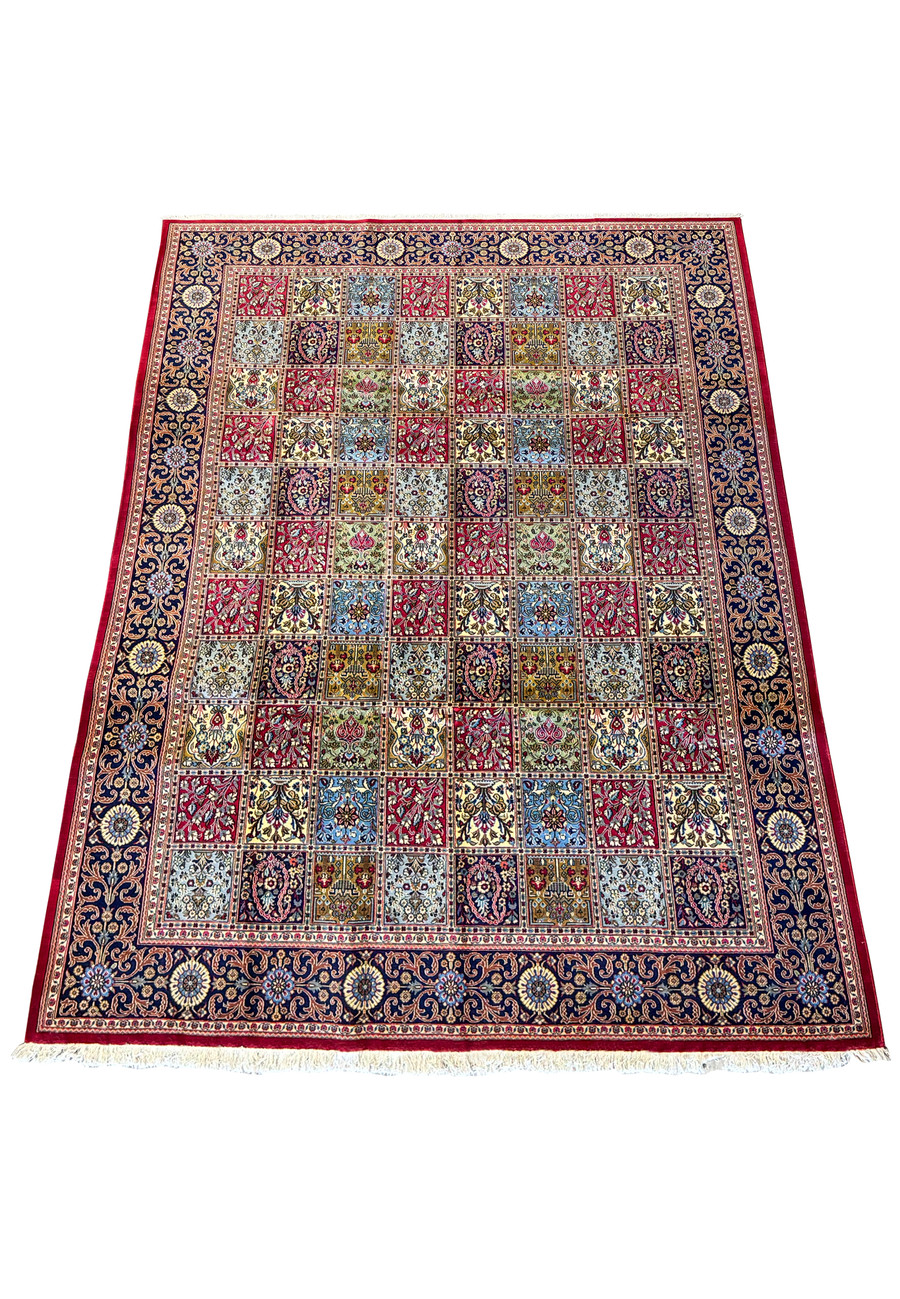 Overhead full shot of an 8 x 11'3 luxury Persian Qum Kork rug displaying a grid of ornate floral patterns and a richly decorated navy border