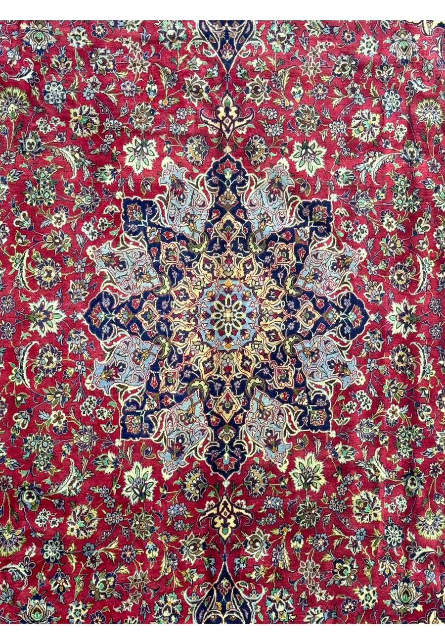 Corner detailing of Persian Isfahan rug - Close-up of the corner section of the Persian Isfahan rug, showing the complex border designs and rich coloration.