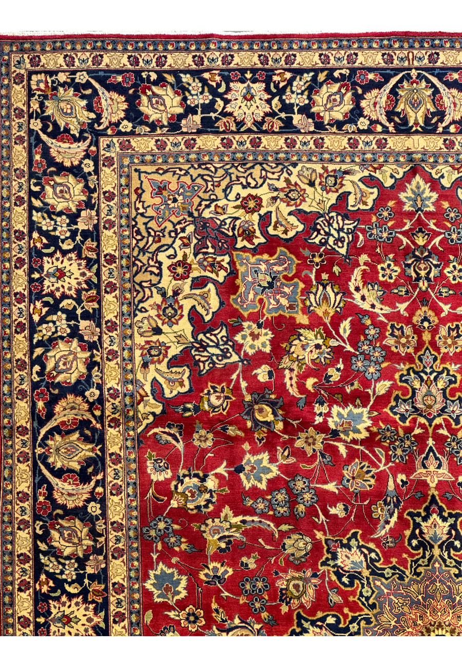 Corner view of a Persian Isfahan rug, showing the intricate border design and vibrant colors.