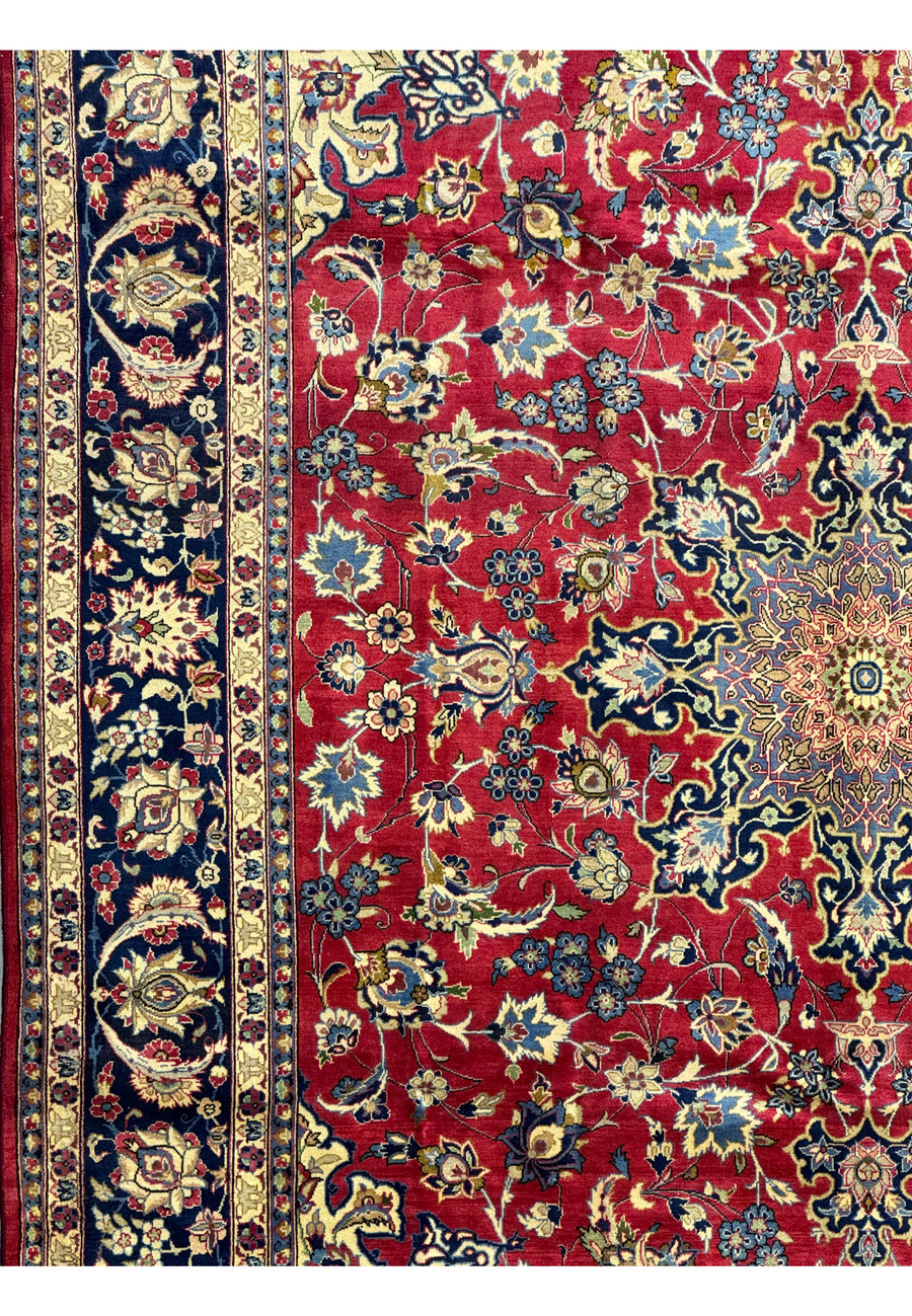 Close-up of the floral motifs on a Persian Isfahan rug, with blue, gold, and red details.