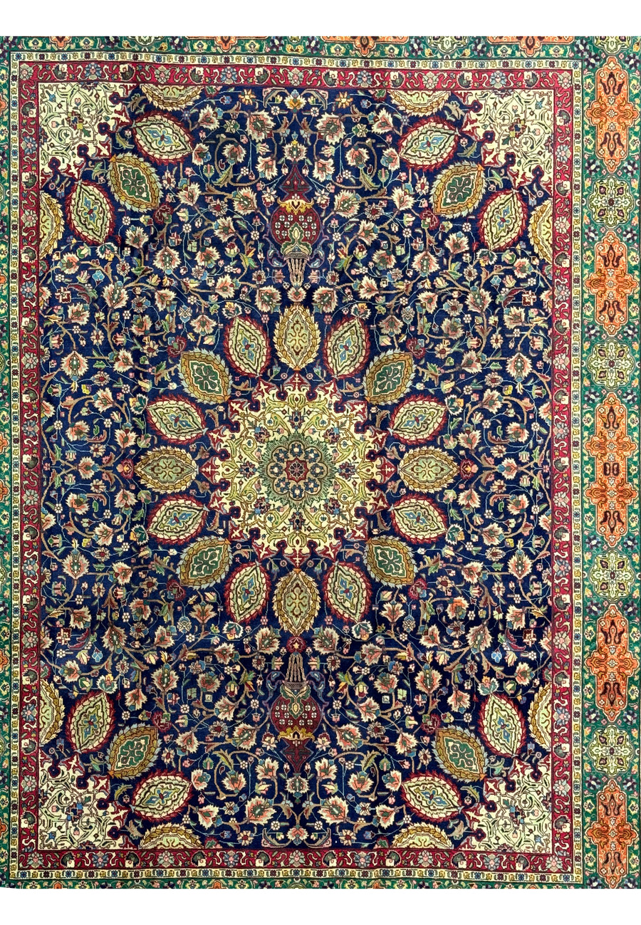 Full view of a 10'5 x 13 Persian Tabriz Rug, showcasing the complete design. The rug features a central medallion with complex floral patterns radiating outward, set against a deep navy blue background. The borders are richly decorated with intricate motifs in red, green, and gold, framed by a wider border of geometric and floral designs in complementary colors. The high knot density and quality wool ensure both durability and a luxurious feel.