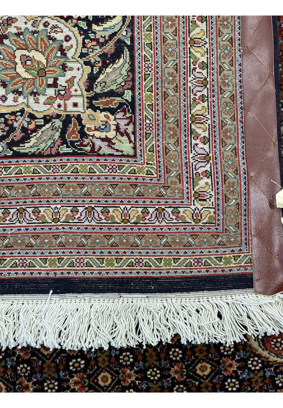 Detailed close-up of the back of a 11'7 x 16'6 Persian Tabriz Mahi 50 Raj rug from a different perspective, highlighting the intricate patterns and high knot density, showcasing the durability and exceptional quality of this premium wool and silk handmade rug.
