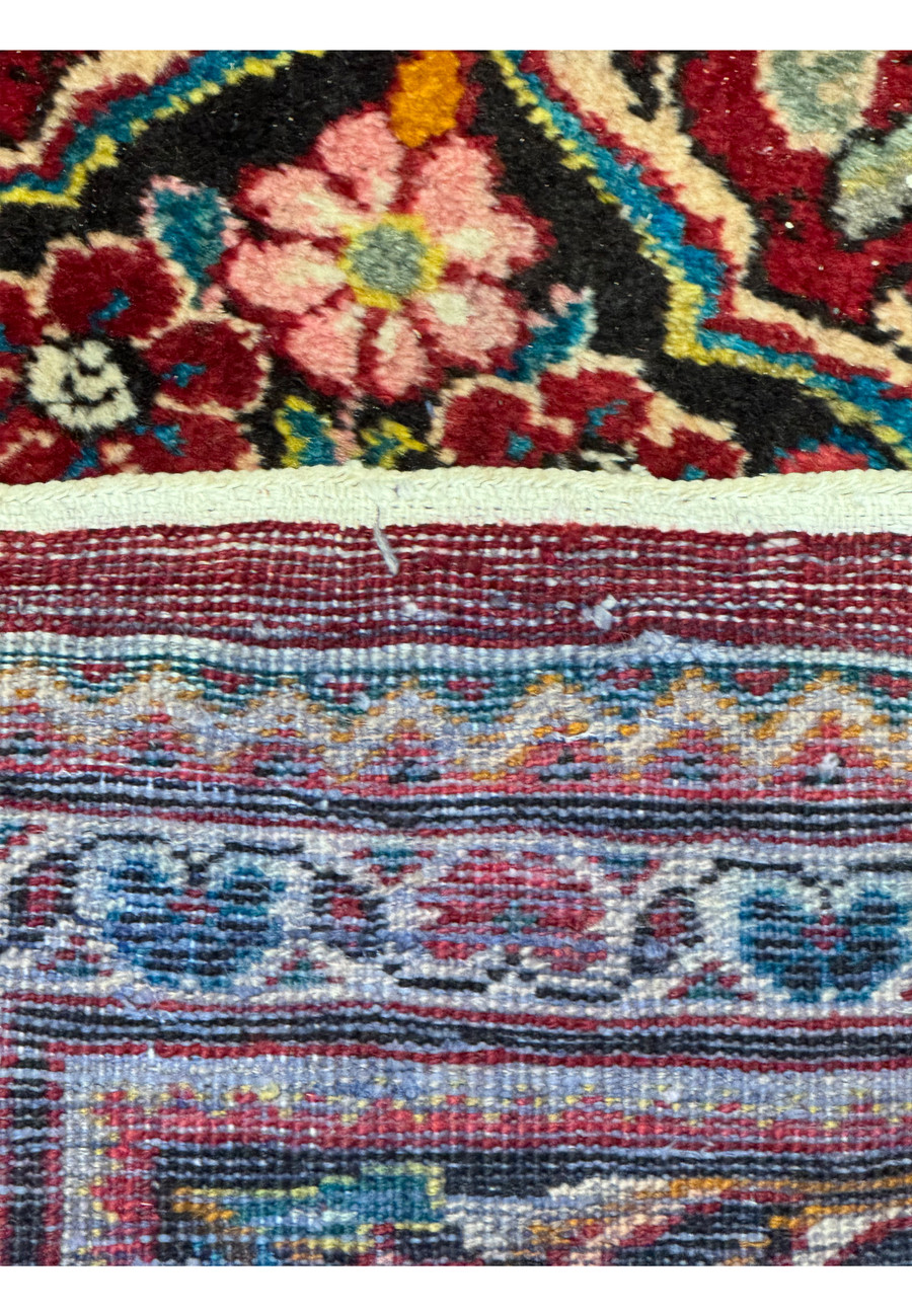 Underside view of a 10'7 x 13'5 Persian Mahal rug showcasing the cotton foundation.