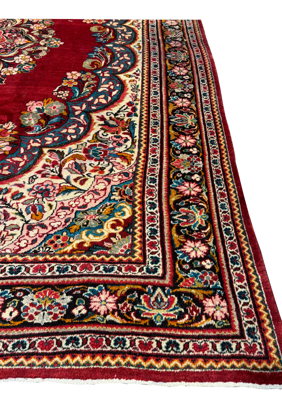 Side angle of a 10'7 x 13'5 Persian Mahal rug displaying its detailed border and central medallion.