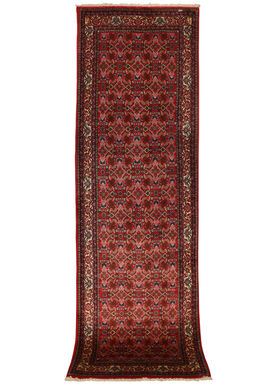 An angled view of the 3' x 9'9" Persian Bijar runner rug, capturing the depth and texture of the intricate patterns. The combination of floral and geometric designs is highlighted in rich, contrasting colors.