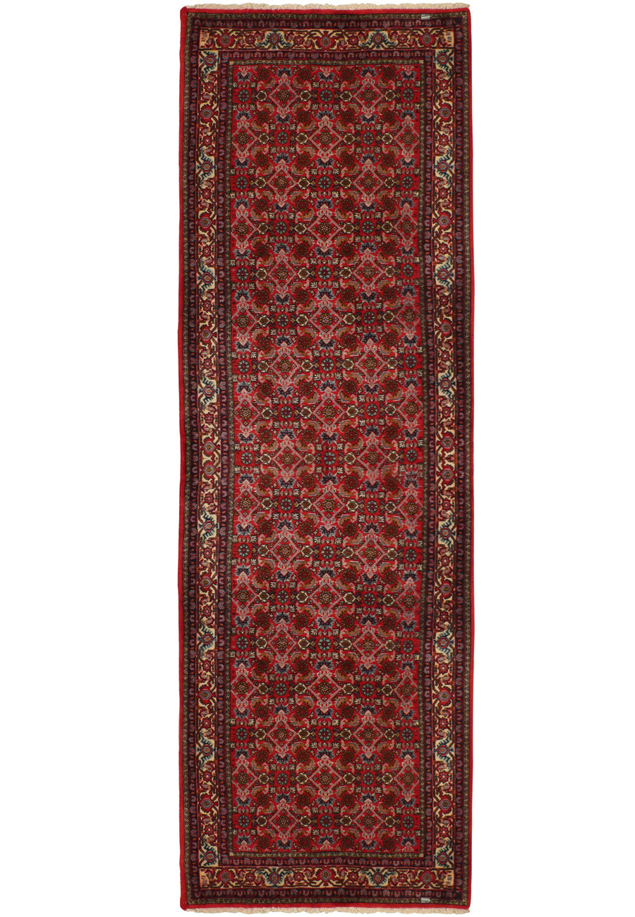 Full view of the 3' x 9'9" Persian Bijar runner rug, laid out flat to display its complete design. The rug features a dominant red color palette with intricate patterns and border details, typical of traditional Persian artistry.