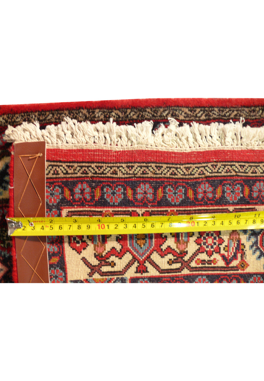 Another close-up of the border and fringe of the Persian Bijar runner rug, showcasing the precise craftsmanship and intricate design elements. The rich red, blue, and ivory colors are prominent.