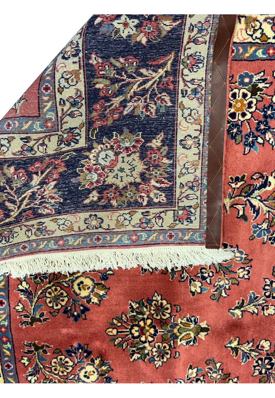 Detailed view of the reverse side of a Persian Yazd rug, illustrating the precise hand-knotted construction and the vibrant color patterns visible through the back weave.