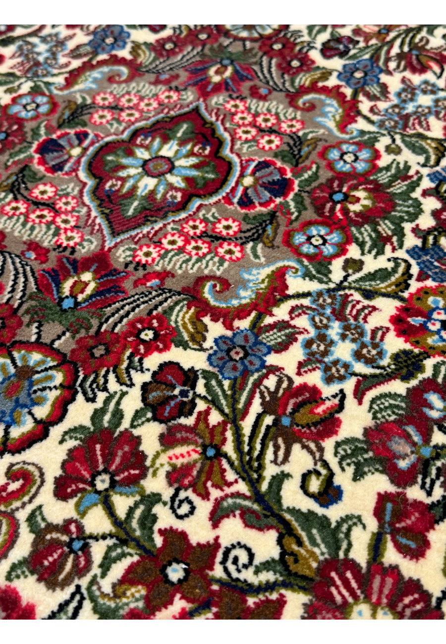 Detailed view of the floral patterns on a Qum Kork rug