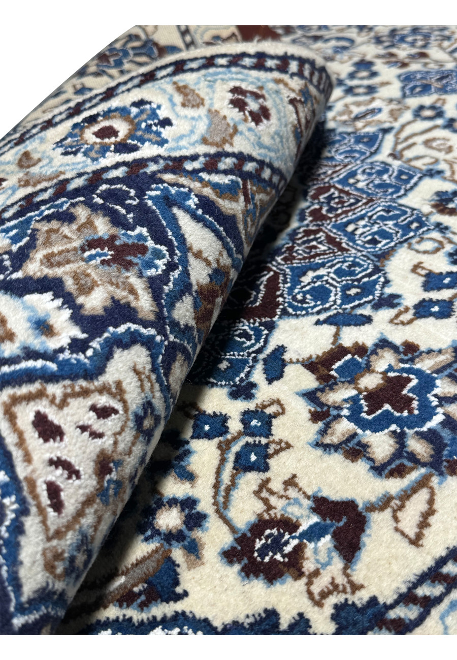 Rolled view of 3 x 4'9 Nain Persian Rug illustrating texture and thickness.