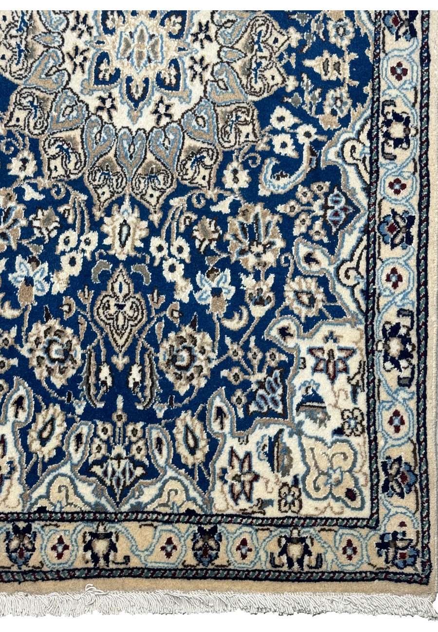 Edge view of the 3x5 Persian Nain Rug, showing the detailed border design and the fringe.