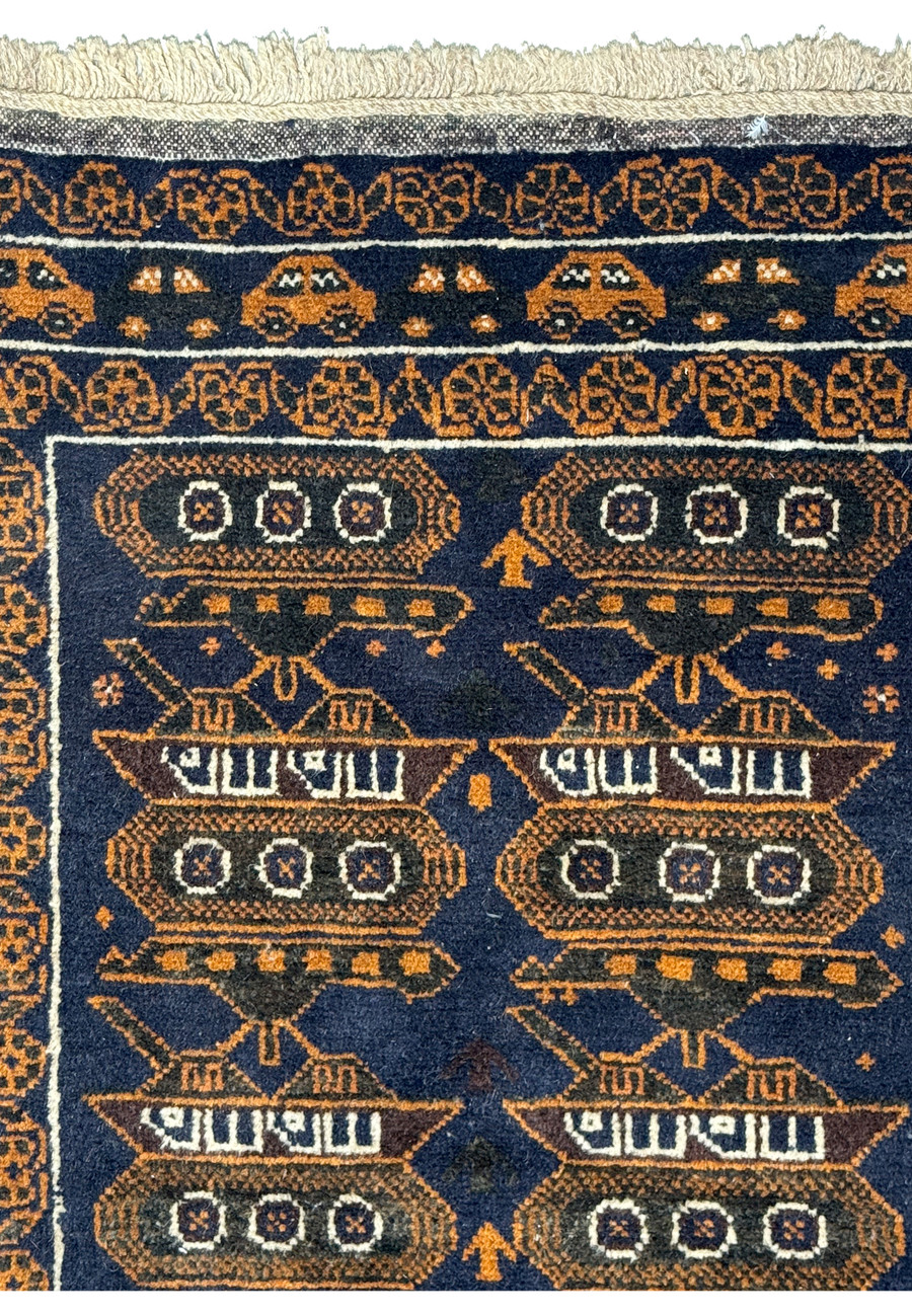 Upper part of the 2'9 x 4'4 Persian Baluch Rug displaying the detailed border and tank designs.