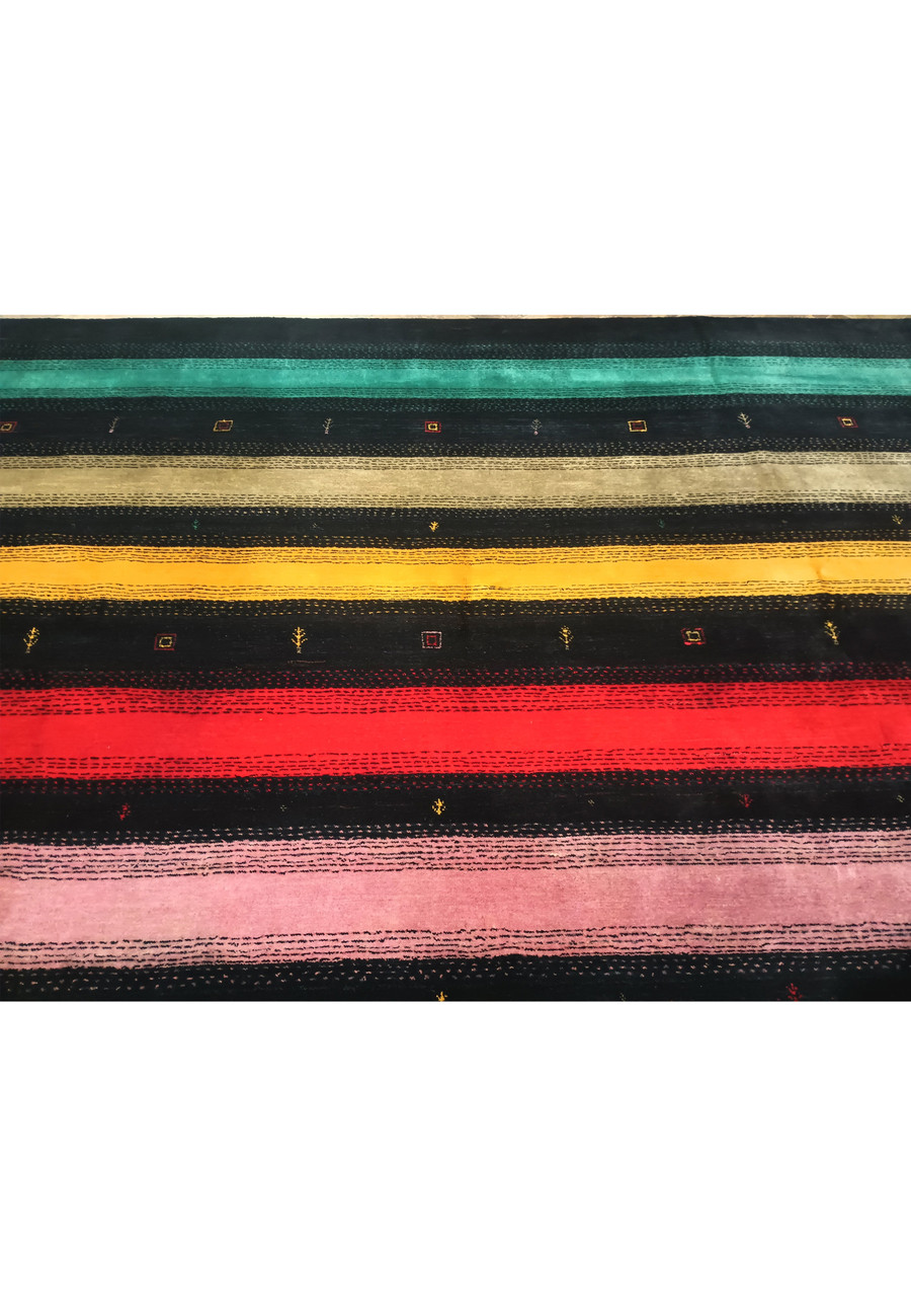 Midfield of 8'3" x 9'11" colorful Gabbeh rug showcasing its unique patterns.