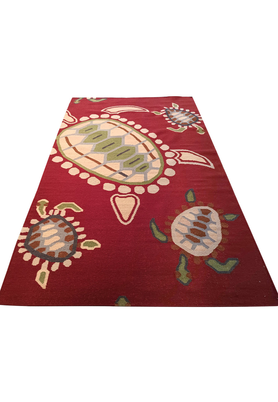 Handmade wool rug with playful turtle design.