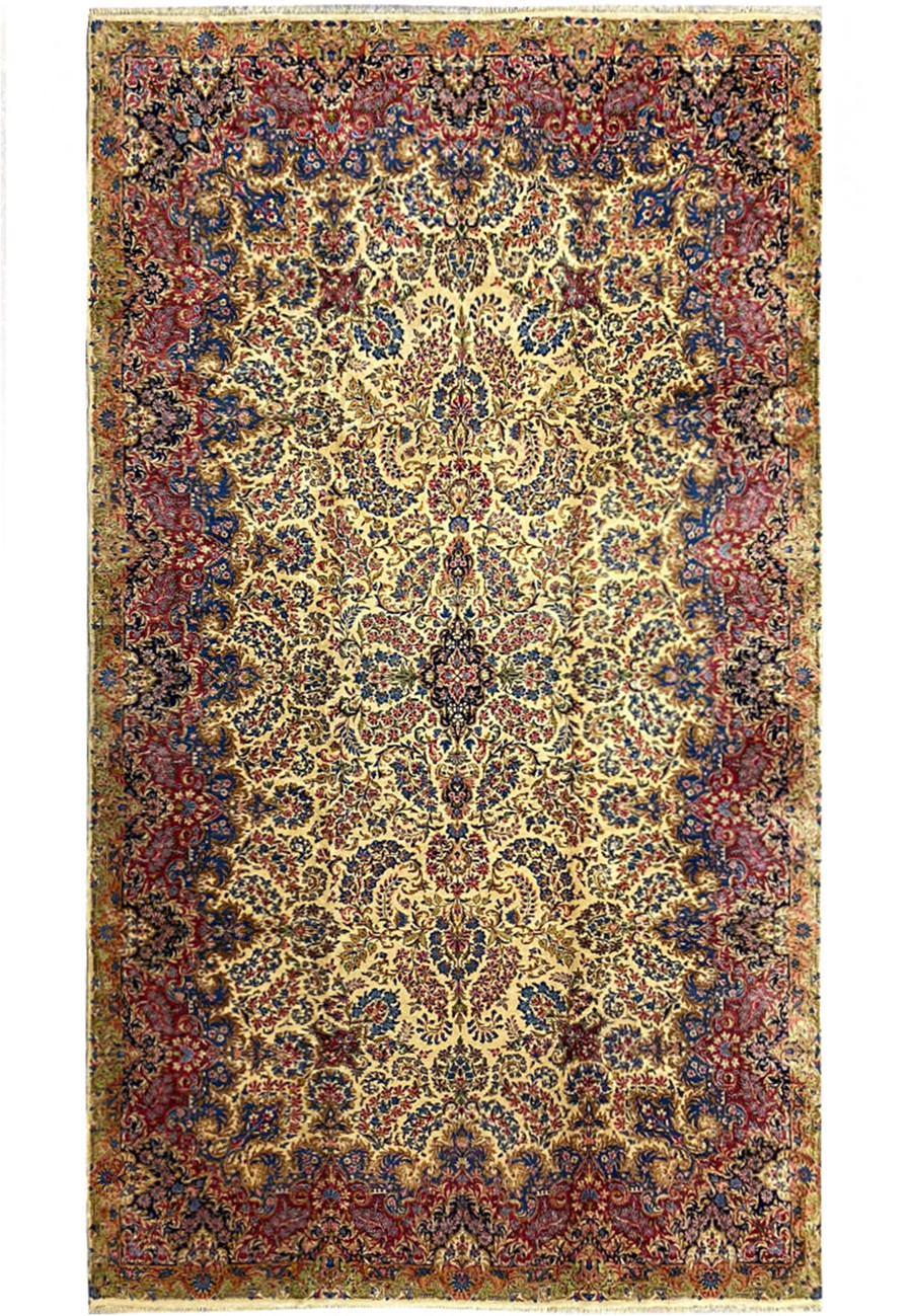 Full view of a large 9' x 17'8" Antique Persian Kerman Lavar Rug in cream, navy, burgundy, and blue tones.