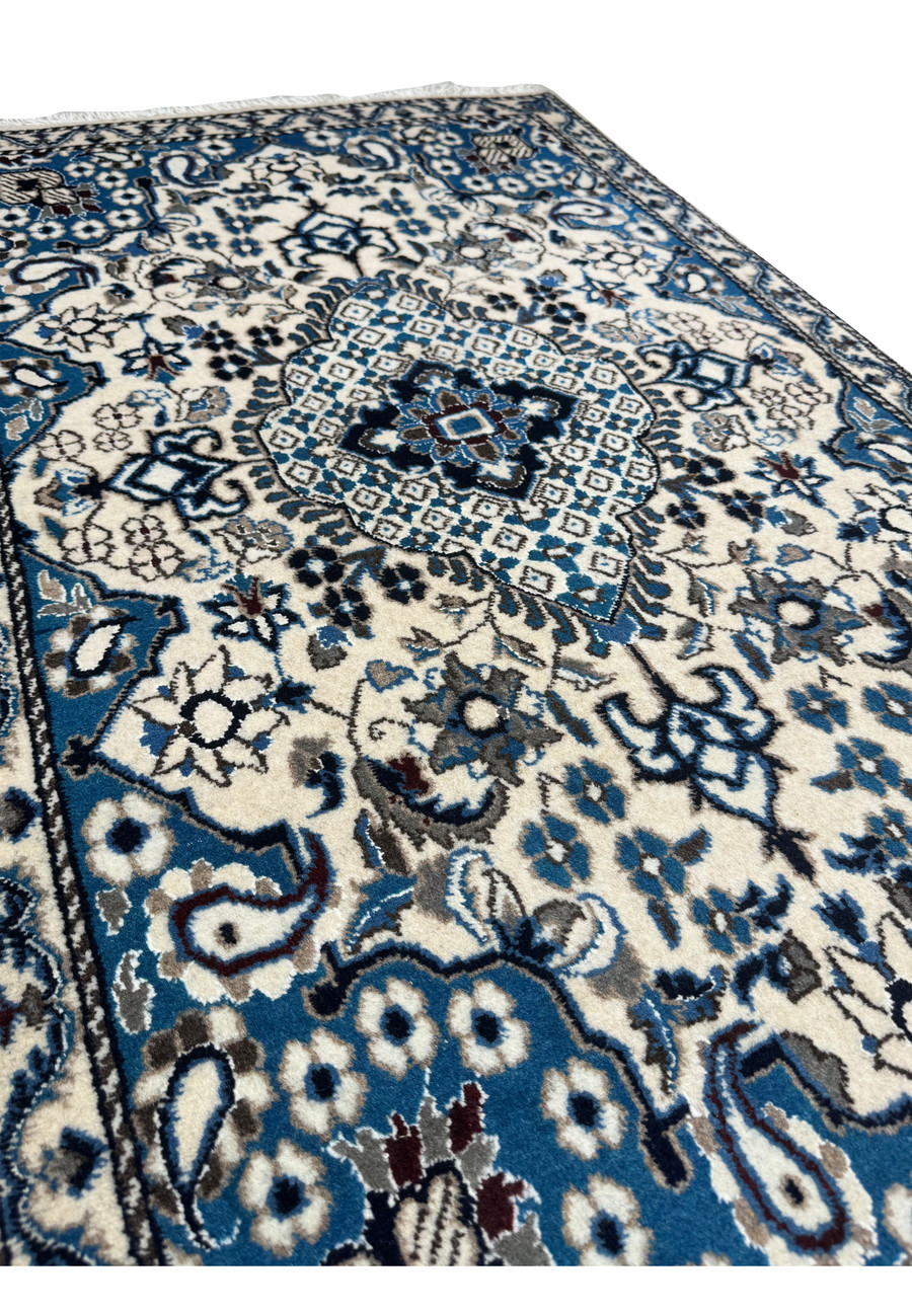 Angled view of the 2'9 x 4'7 Persian Nain Rug laid down, showcasing its texture.