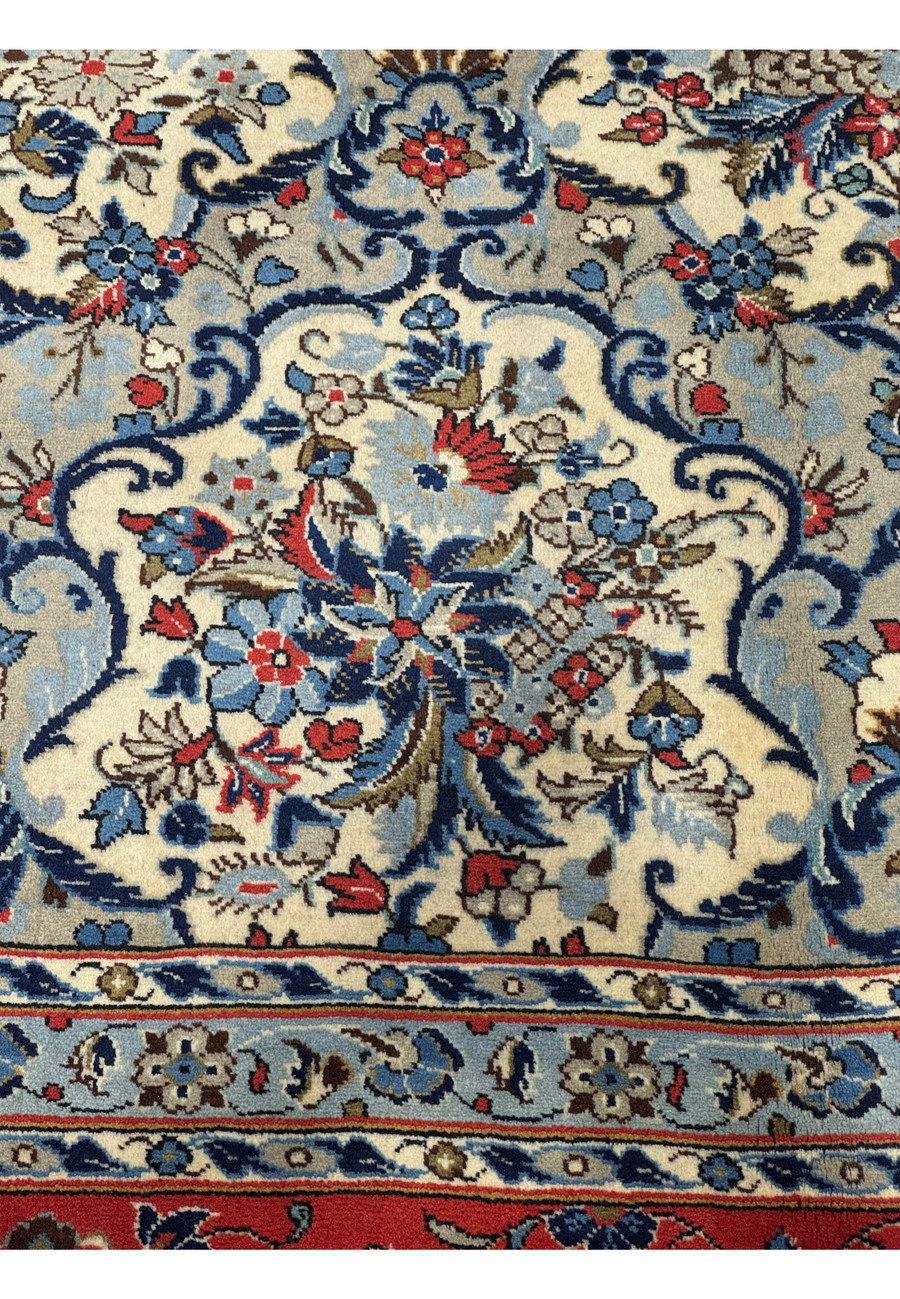 Close-up of the floral arabesque pattern on the 8'2 x 11'6 Persian Kashan Rug in blue, ivory, and red showing Shah Abbasi palmettes and rosettes