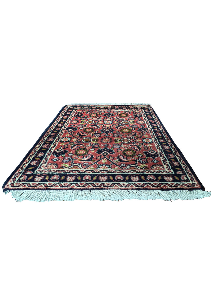 The 1'3 x 2' Persian Baby Bijar Rug laid flat on the floor, displaying its vibrant red and navy pattern.