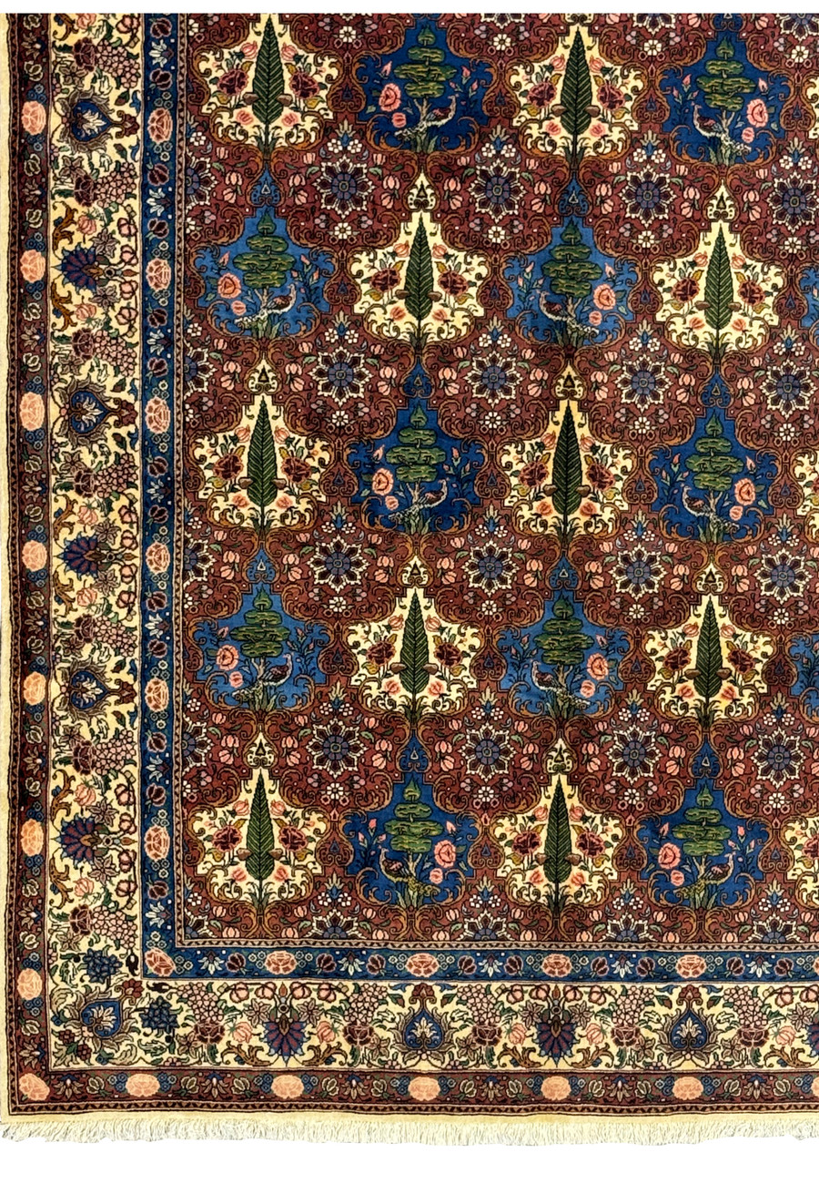 Close-up of the detailed floral border on a Persian Bakhtiar Rug with vibrant leaf and vine patterns.
