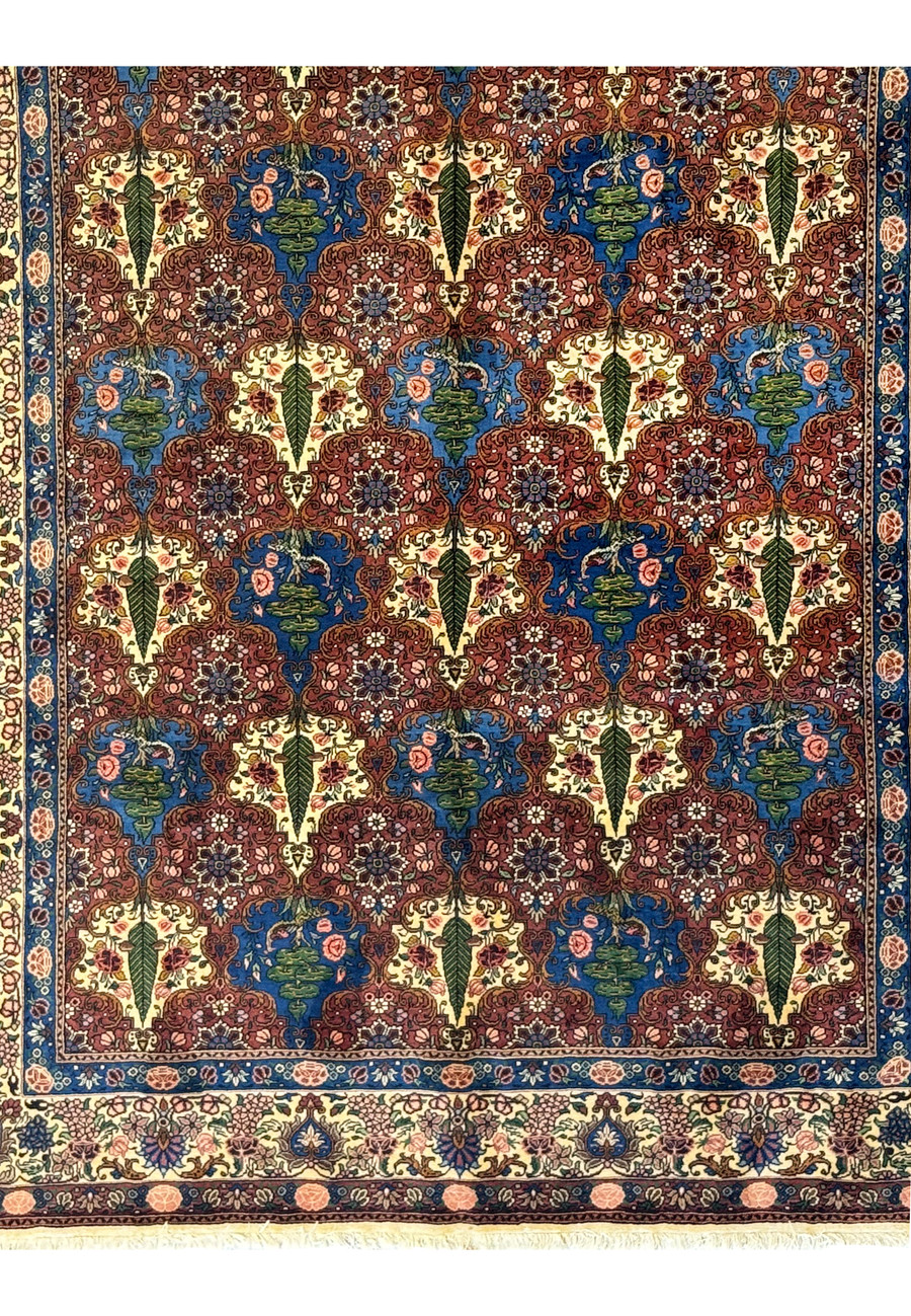 View of the lower part of a Persian Bakhtiar Rug, featuring tree-of-life motifs and birds.