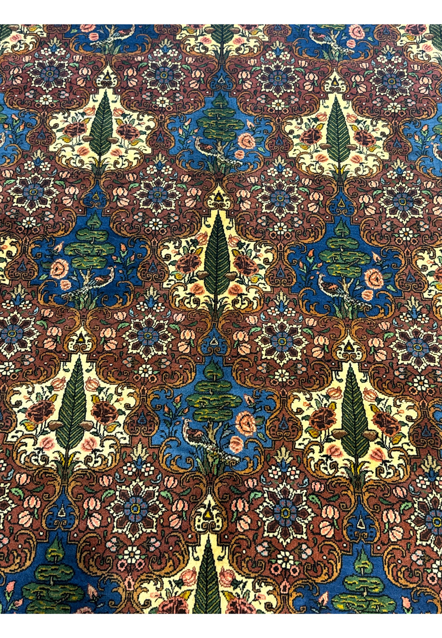 Close-up of the trees and leaf motifs in a Persian Bakhtiar Rug, representing the tree of life and natural elements.