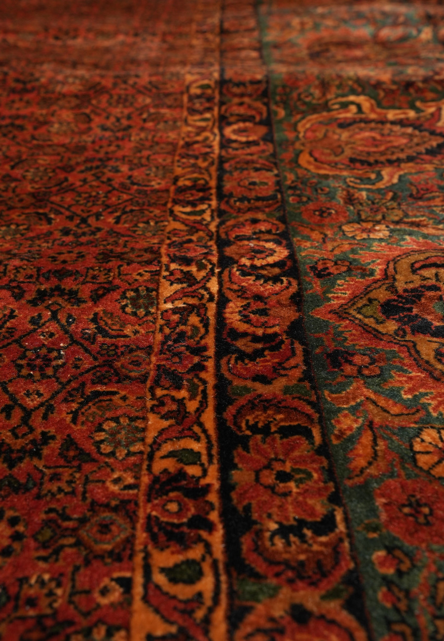 Detailed view of rust red field with repeating rosettes and diamond lattice