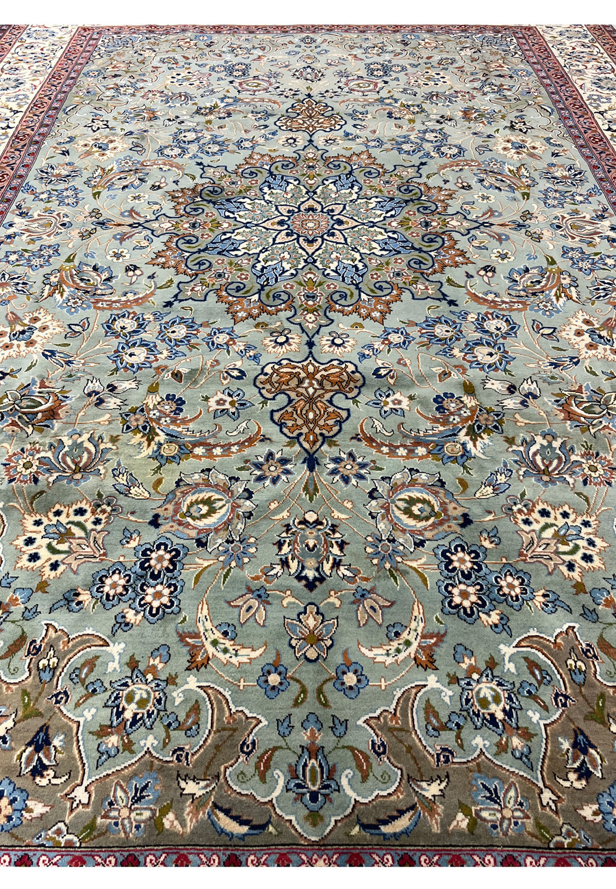 Wide midfield view of Persian Tabriz rug highlighting the detailed medallion and floral design on a soft sage-green background
