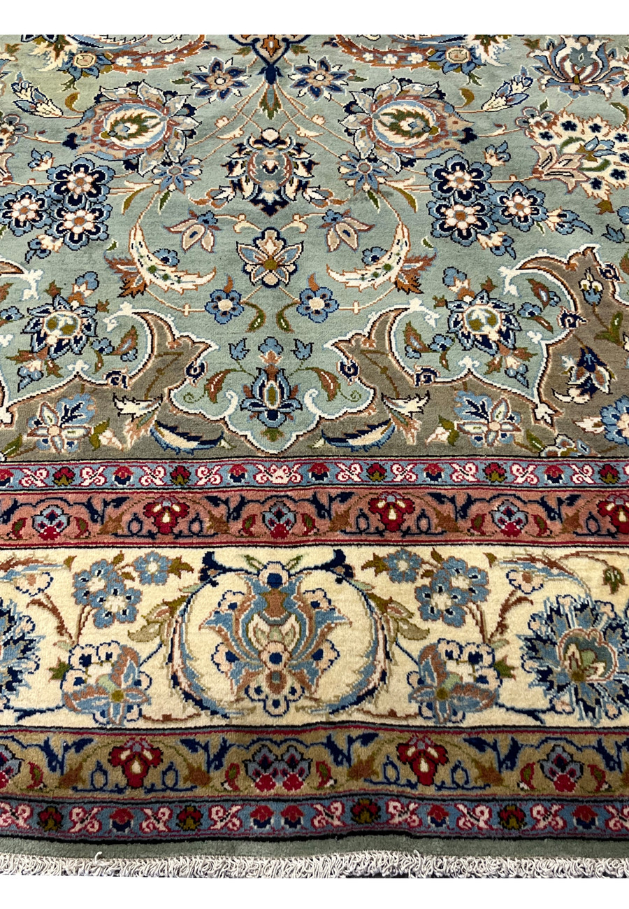 Lower edge of Persian Tabriz rug with ivory border, burgundy guard stripes, and fine hand-knotted floral motifs