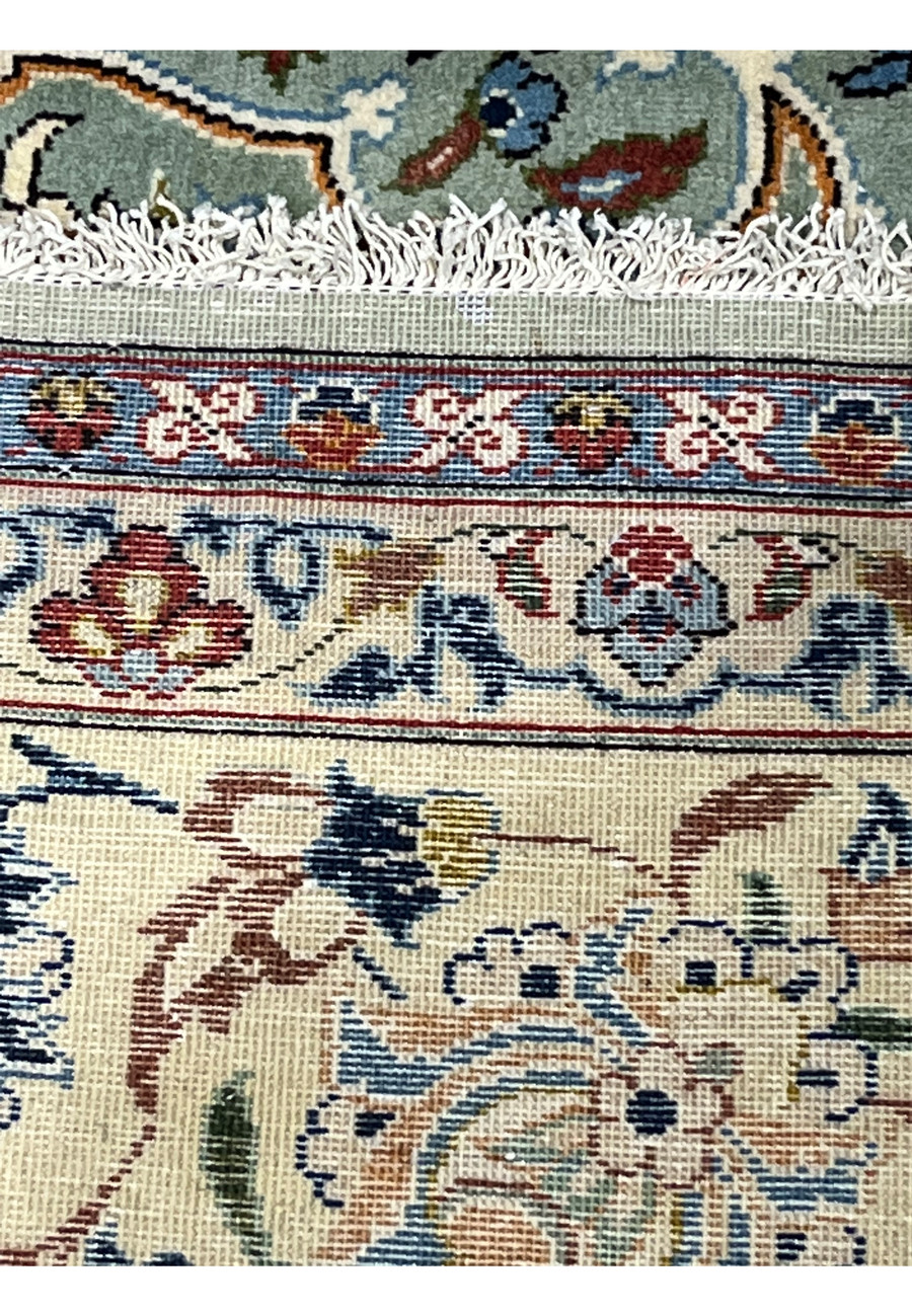 Backside close-up of Persian Tabriz rug displaying hand-knotted weave structure and tight knot density