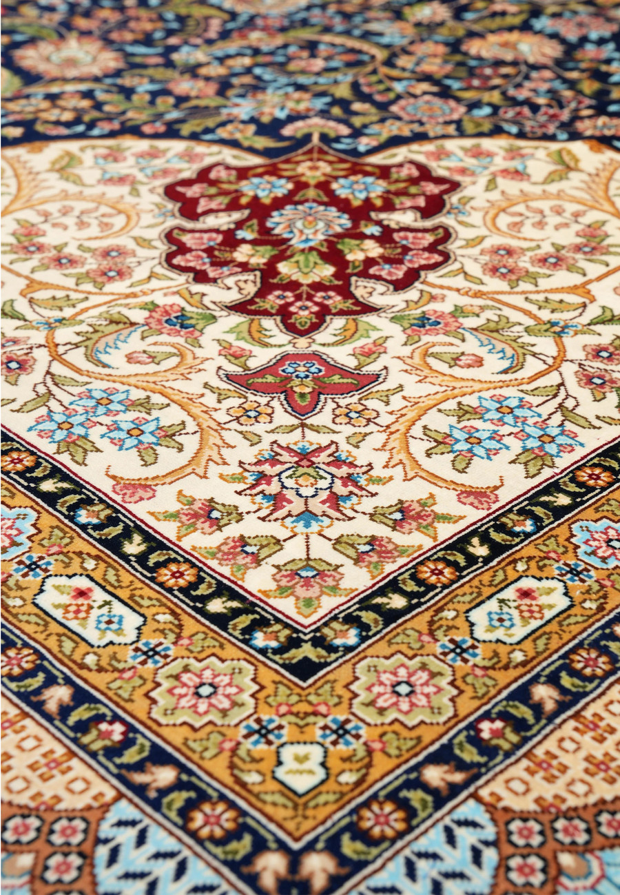 Angled perspective showing the sheen of silk threads and depth of color across the intricate floral design.