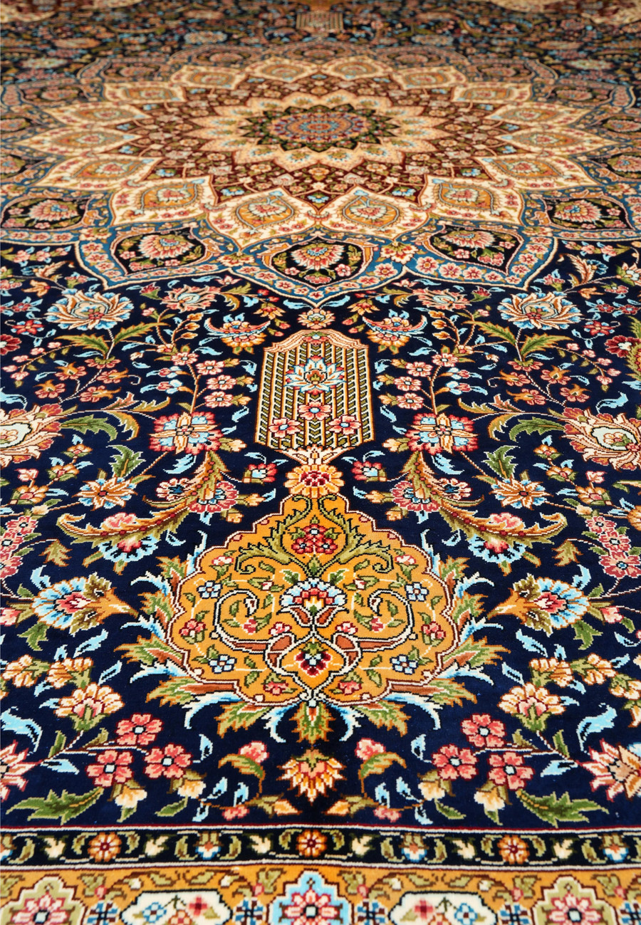 Detailed midfield view showing intricate silk weaving and floral motifs in navy, burgundy, and ivory tones.