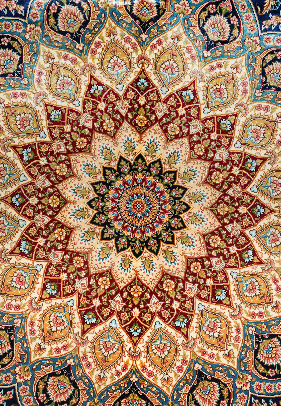 Close-up of the radiant central medallion with lotus and rosette patterns surrounded by ornate vines.