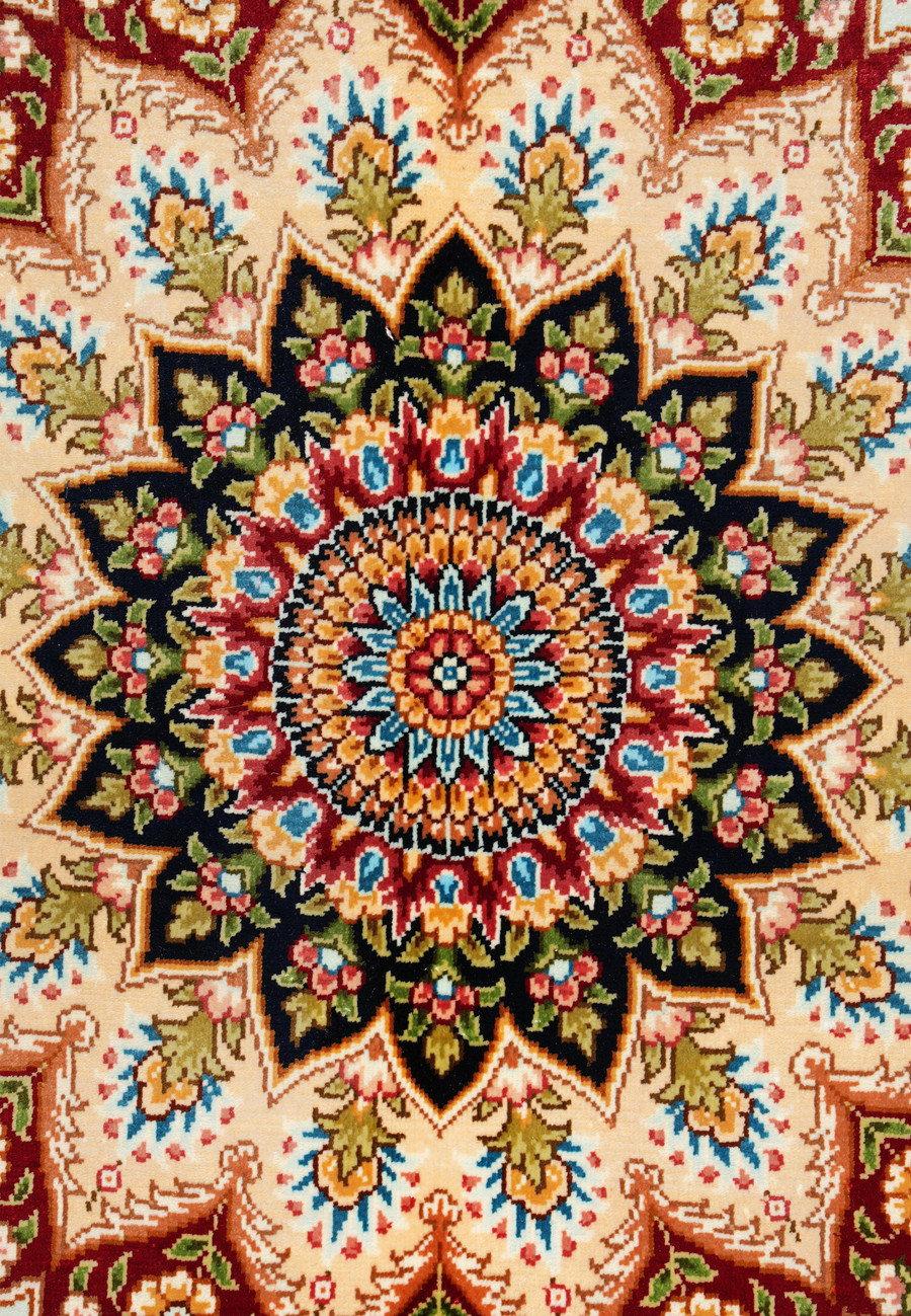 Extreme close-up capturing the precision of silk knotting and fine detailing within the medallion petals.