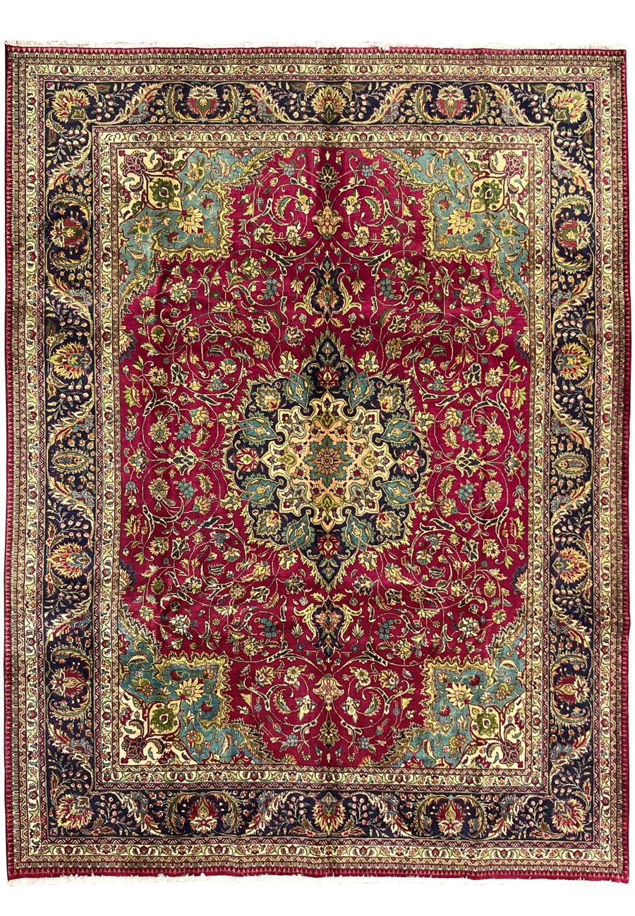full view of 9'9 x 12'4 vintage Persian Tabriz rug with wine red field, ivory and navy medallion, teal corners, and ornate floral borders