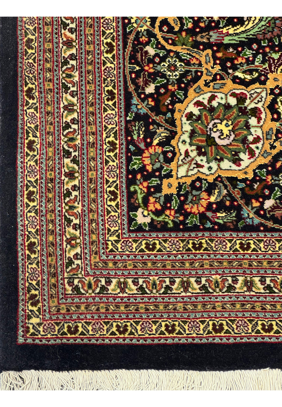High detail view of the border design in a Persian Tabriz Mahi rug emphasizing symmetry, color restraint, and traditional craftsmanship