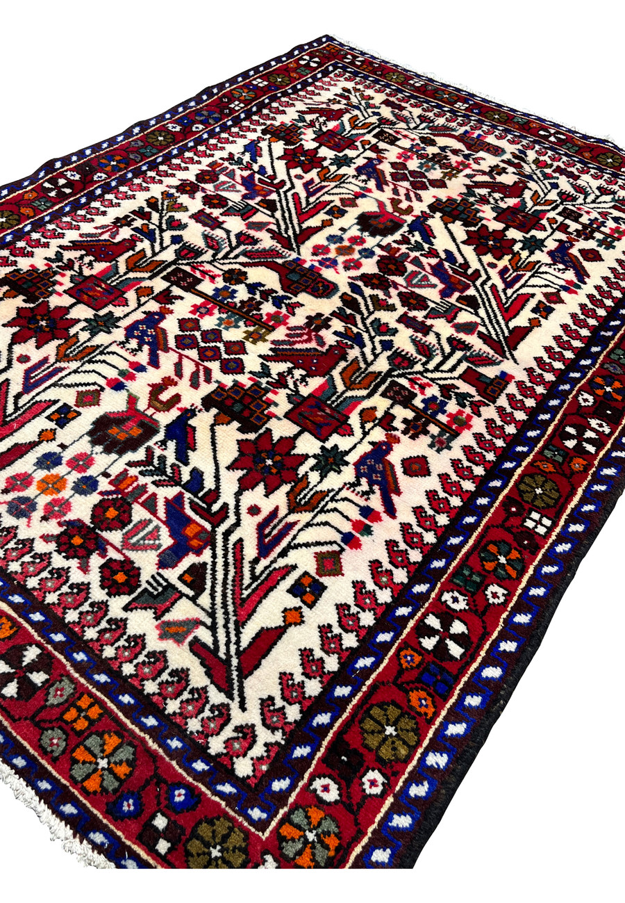 Angled perspective of Persian Rudbar village rug showing pile height, dense wool texture, and harmonious allover tribal design.