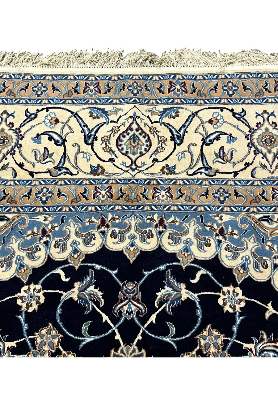 Upper border close-up of Persian Nain rug highlighting floral vines, balanced spacing, ivory and blue tones, and refined Persian craftsmanship